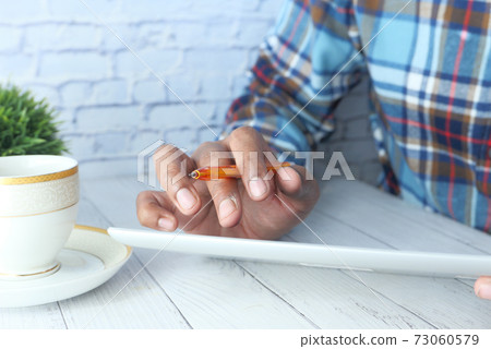 business man using digital tablet on office desk  73060579