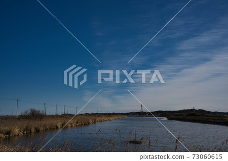 Clear sky and clouds in winter, sky, utility poles and lake 73060615