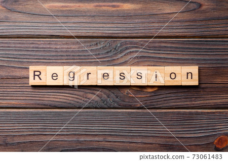 regression word written on wood block. regression text on cement table for your desing, concept regression word written on wood block. regression text on cement table for your desing, concept 73061483