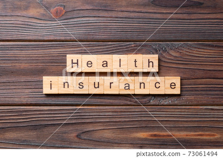 Health insurance word written on wood block. Health insurance text on wooden table for your desing, concept 73061494