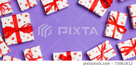 Top view of gift boxes with red hearts on colorful background. St Valentine's day concept with copy space Top view of gift boxes with red hearts on colorful background. St Valentine's day concept with copy space 73061612