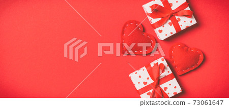 Top view colorful valentine background made of gift boxes and red textile hearts. Valentine's Day concept with copy space Top view colorful valentine background made of gift boxes and red textile hearts. Valentine's Day concept with copy space 73061647