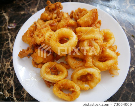 Squid cut into small pieces and fried with flour. The flour has been mixed with eggs to add flavour and to make it crisper. Squid cut into small pieces and fried with flour. The flour has been mixed with eggs to add flavour and to make it crisper. 73064009