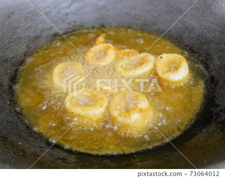 Squid cut into small pieces and fried with flour. The flour has been mixed with eggs to add flavour and to make it crisper. Squid cut into small pieces and fried with flour. The flour has been mixed with eggs to add flavour and to make it crisper. 73064012
