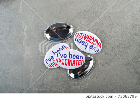 Vaccination campaign button pins on stone tabletop flat lay view 73065799