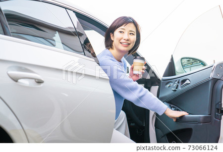 A young woman driving A young woman driving 73066124