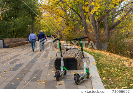 Calgary City electric scooters (e-scooter). Prince's Island Park in Autumn season, AB, Canada Calgary City electric scooters (e-scooter). Prince's Island Park in Autumn season, AB, Canada 73066602