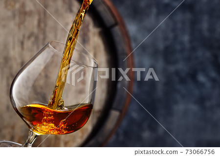 brandy pouring into glass 73066756