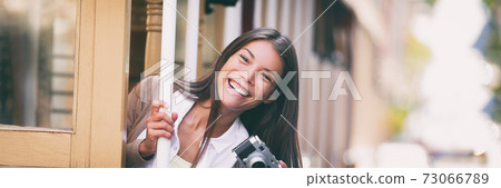 Smiling Asian woman taking pictures on Trolley street car ride with vintage camera panoramic banner. Tourist riding public transit tramway system in San Francisco Smiling Asian woman taking pictures on Trolley street car ride with vintage camera panoramic banner. Tourist riding public transit tramway system in San Francisco 73066789