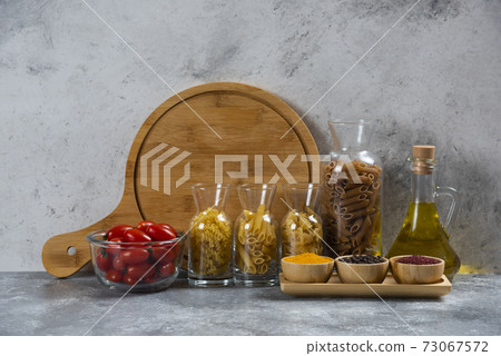 Different types of pasta with cherry tomatoes 73067572