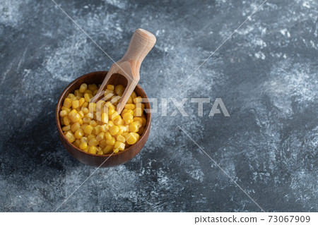 Bowl of sweet corns on marble background Bowl of sweet corns on marble background 73067909