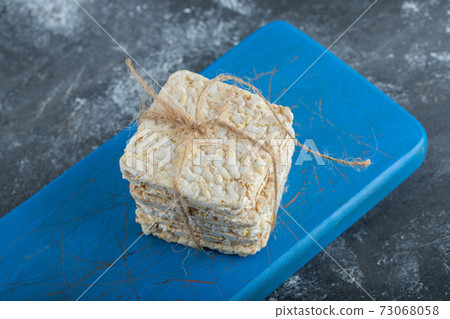 Crisp bread in rope on a wooden cutting board 73068058