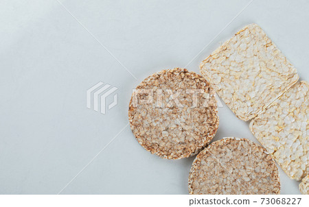 Two types of crispbread on white background Two types of crispbread on white background 73068227