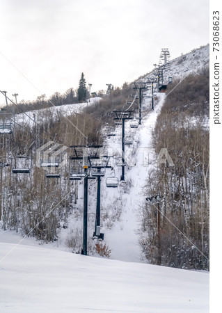 Ski lifts over snowy mountain in Park City Utah Ski lifts over snowy mountain in Park City Utah 73068623