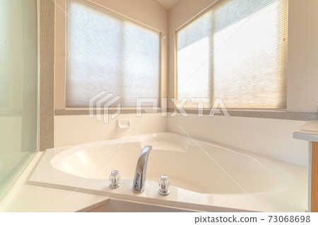 Luxurious bath tub with bright, warm window light Luxurious bath tub with bright, warm window light 73068698