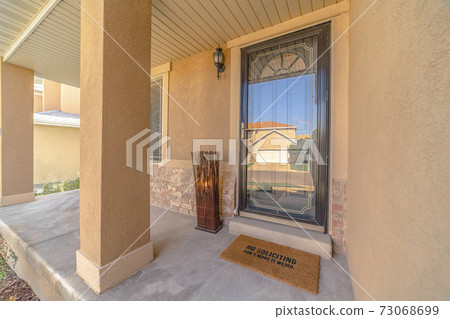 Front door and veranda of modern rendered home Front door and veranda of modern rendered home 73068699