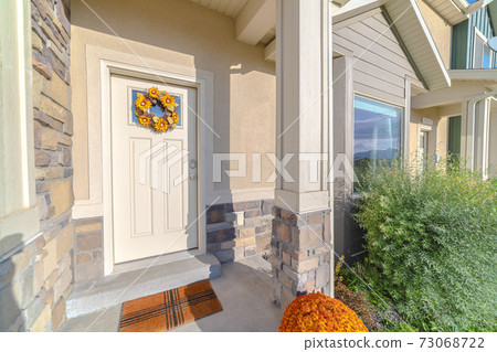 Front door of modern home with sunflower wreath Front door of modern home with sunflower wreath 73068722