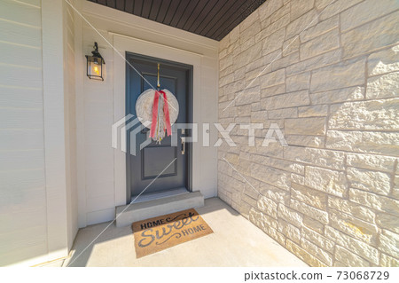 Front door of suburban home with welcome mat Front door of suburban home with welcome mat 73068729