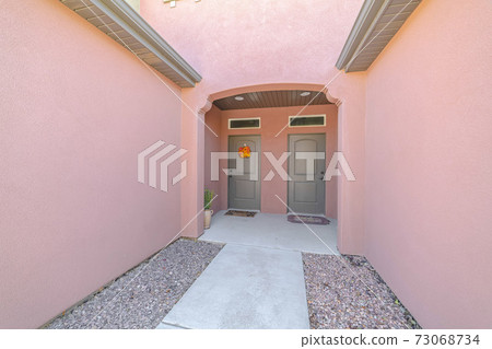 Front doors and porch of modern pink duplex Front doors and porch of modern pink duplex 73068734