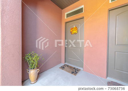 Dual front doors and porch of pink townhouse Dual front doors and porch of pink townhouse 73068736