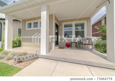 Front veranda of modern home with welcome sign 73068779