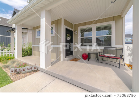 Front porch of modern home with welcome sign Front porch of modern home with welcome sign 73068780