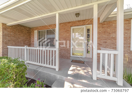Front porch and door of traditional brick home Front porch and door of traditional brick home 73068797