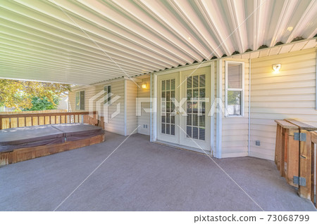 Veranda area of traditional home with covered spa Veranda area of traditional home with covered spa 73068799