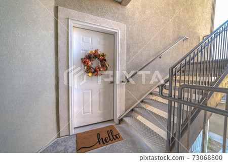 Apartment front door with welcome mat and wreath Apartment front door with welcome mat and wreath 73068800