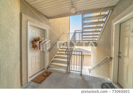Front door of apartment from exterior stairwell Front door of apartment from exterior stairwell 73068801