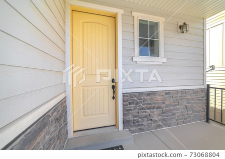 Front veranda of suburban home with a yellow door Front veranda of suburban home with a yellow door 73068804