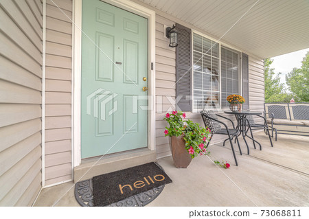 Front door of suburban home with welcome mat Front door of suburban home with welcome mat 73068811