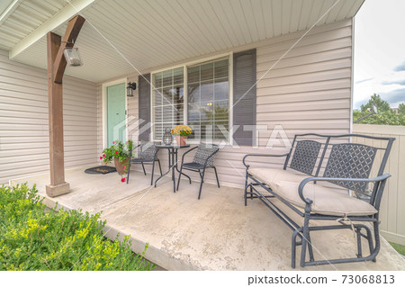Front porch of modern home with outdoor furniture 73068813
