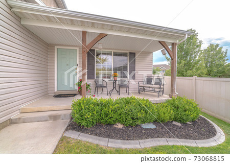 Front veranda of modern home and landscaped garden Front veranda of modern home and landscaped garden 73068815