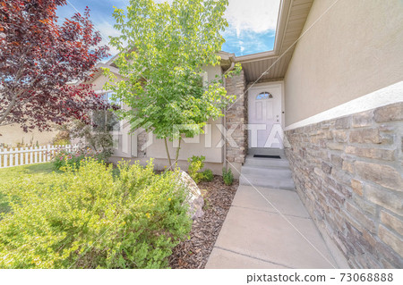 Walkway through garden to door of modern house 73068888