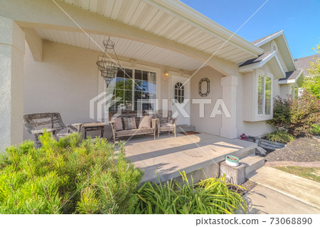 Front porch and garden of a traditional home Front porch and garden of a traditional home 73068890