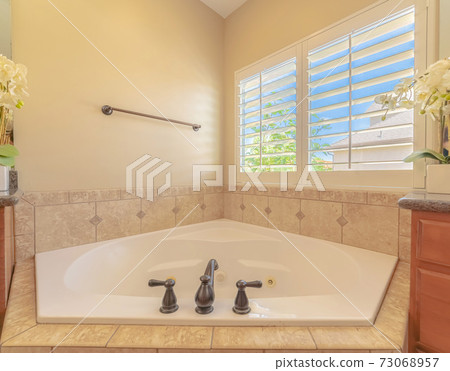 Spa bath with window light in contemporary home Spa bath with window light in contemporary home 73068957