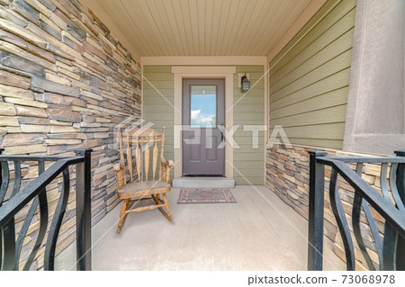 Front porch of modern house with rocking chair Front porch of modern house with rocking chair 73068978