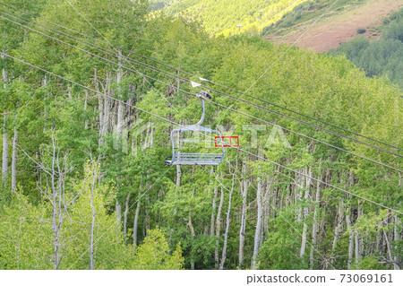 Scenic view of trees and hiking trails from a chairlift at Park City off season Scenic view of trees and hiking trails from a chairlift at Park City off season 73069161