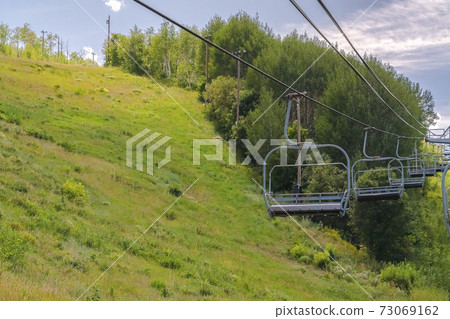 Chairifts and hiking trails at a ski resort in Park City Utah during summer Chairifts and hiking trails at a ski resort in Park City Utah during summer 73069162