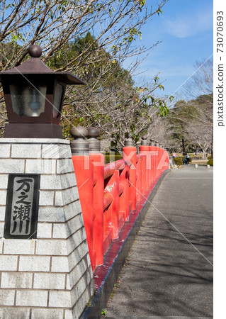 Red railing of the bridge over the Manose River 73070693