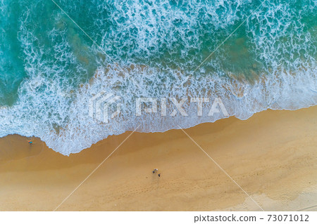Amazing view aerial view drone camera photo of waves crashing on sandy shore,top view of beautiful sandy beach in the morning sunrise Amazing view aerial view drone camera photo of waves crashing on sandy shore,top view of beautiful sandy beach in the morning sunrise 73071012