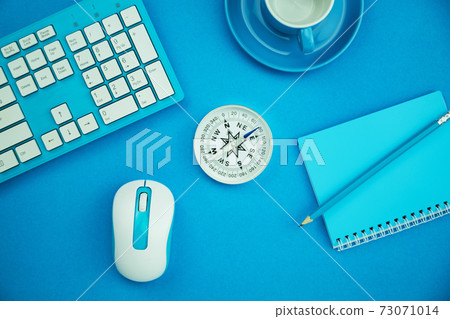 Work from home concept Business objects of coffee cup,compass,keyboard,mouse and paper note with pencil on blue paper table background 73071014