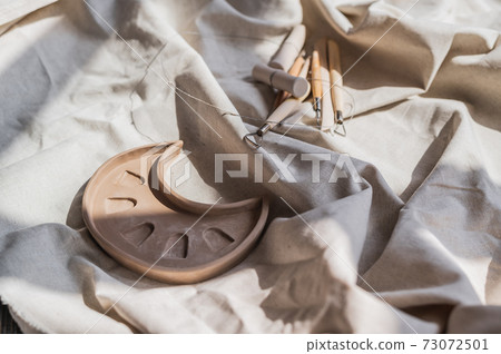 Table with materials and tools for pottery making craftsperson workspace no people creative studio top view 73072501