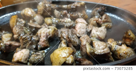 Charcoal grilling of local chicken 73073285