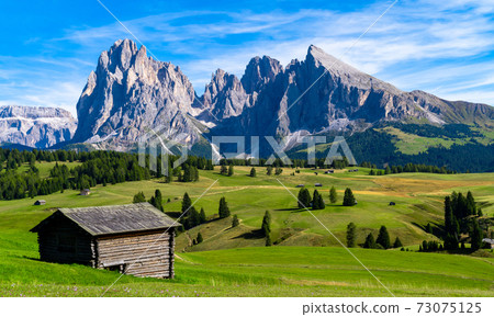 Seceda Mountains at sunset in the Dolomites, Trentino Alto Adige, Val di Funes Valley, South Tyrol in Italy, Odle Mountains in the background. Seceda Mountains at sunset in the Dolomites, Trentino Alto Adige, Val di Funes Valley, South Tyrol in Italy, Odle Mountains in the background. 73075125