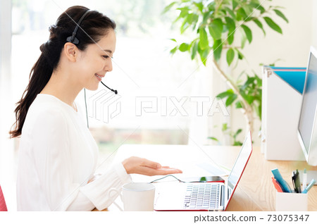Woman having a remote meeting Woman having a remote meeting 73075347