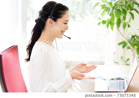 Woman having a remote meeting Woman having a remote meeting 73075348