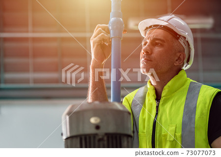Professional engineer service team working maintenance and repair water pipe in factory 73077073