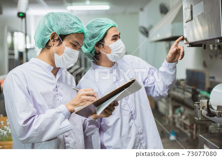 Happy Asian Burmese migrant workers working in Samut Sakhon Thailand hygiene food factory. 73077080